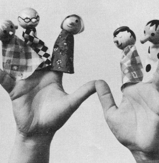 A close-up image of a child’s hands with spread fingers and five finger puppets made by Creative Playthings placed on them.